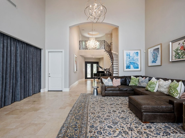 living room with a chandelier and a high ceiling