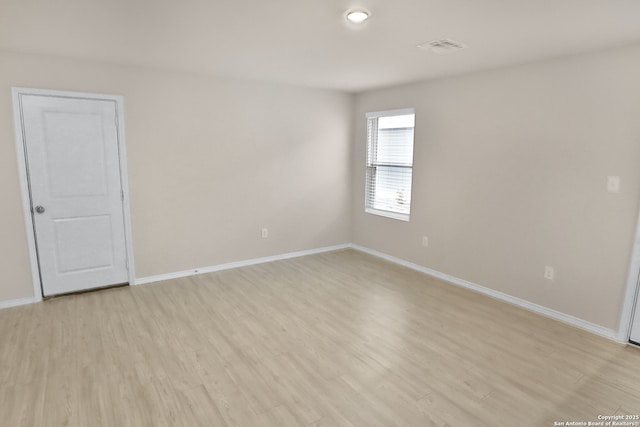 spare room with light hardwood / wood-style floors