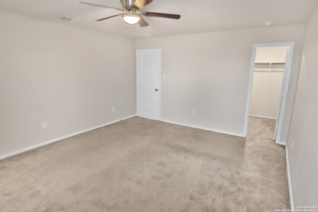 spare room with light colored carpet and ceiling fan