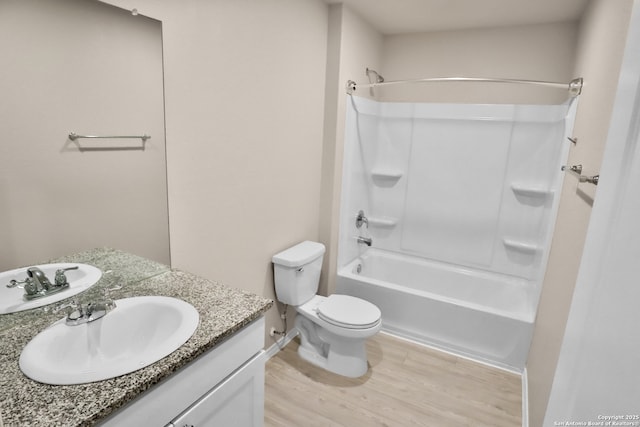 full bathroom featuring hardwood / wood-style flooring, vanity, toilet, and shower / tub combination