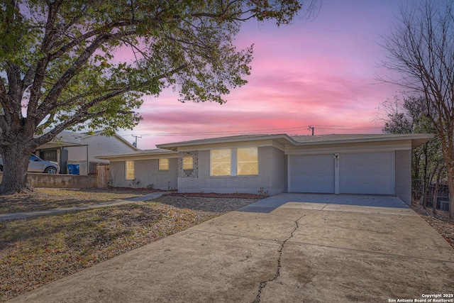 ranch-style home featuring a garage