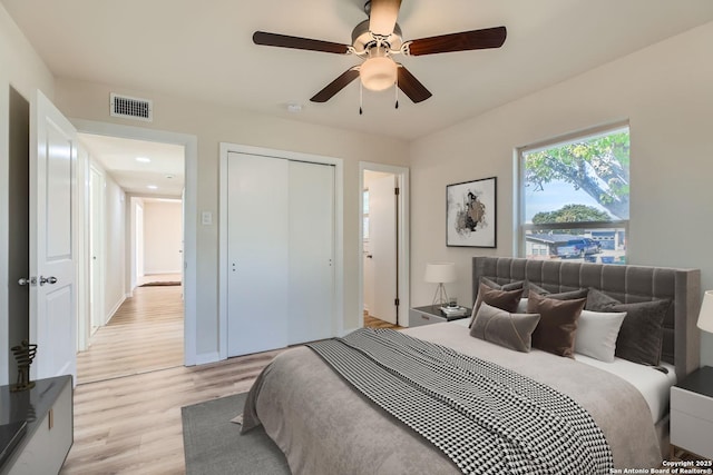 bedroom with a closet, ceiling fan, and light wood-type flooring