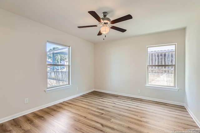 unfurnished room with ceiling fan, light hardwood / wood-style floors, and a wealth of natural light