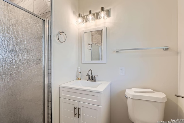 bathroom featuring vanity, toilet, and walk in shower