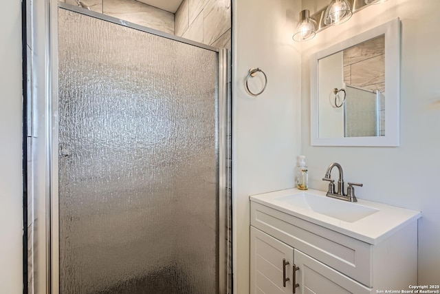 bathroom featuring vanity and a shower with shower door