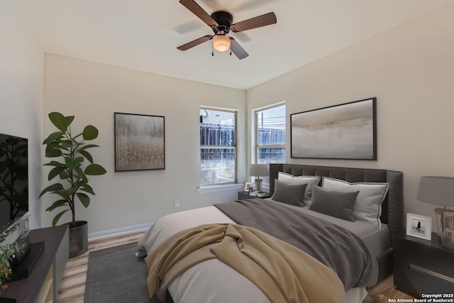 bedroom featuring ceiling fan and light hardwood / wood-style flooring