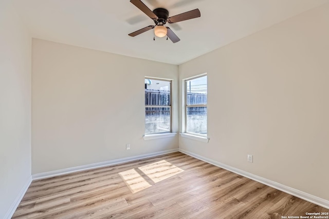 empty room with ceiling fan and light hardwood / wood-style flooring