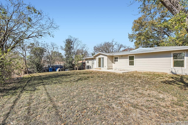 back of house with a patio and a yard