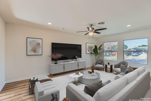 living room with ceiling fan and light wood-type flooring