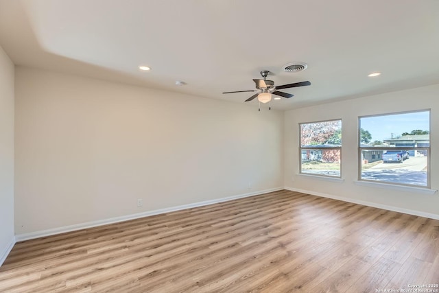 spare room with light hardwood / wood-style floors and ceiling fan