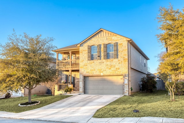 view of front of house featuring a balcony, a garage, and a front yard