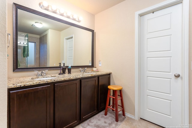 bathroom with tile patterned floors and vanity