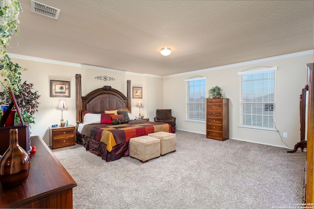 carpeted bedroom with ornamental molding and a textured ceiling