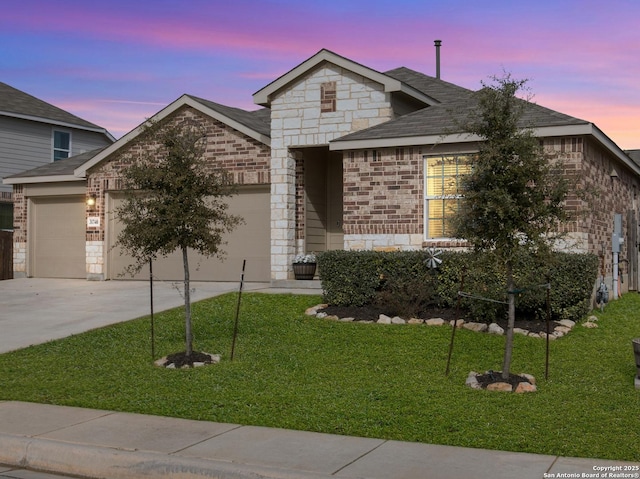 view of front facade with a garage and a lawn