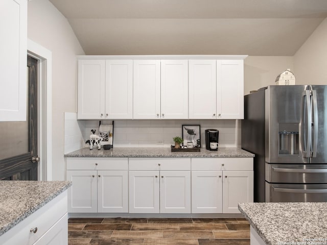 kitchen featuring white cabinets and stainless steel fridge with ice dispenser