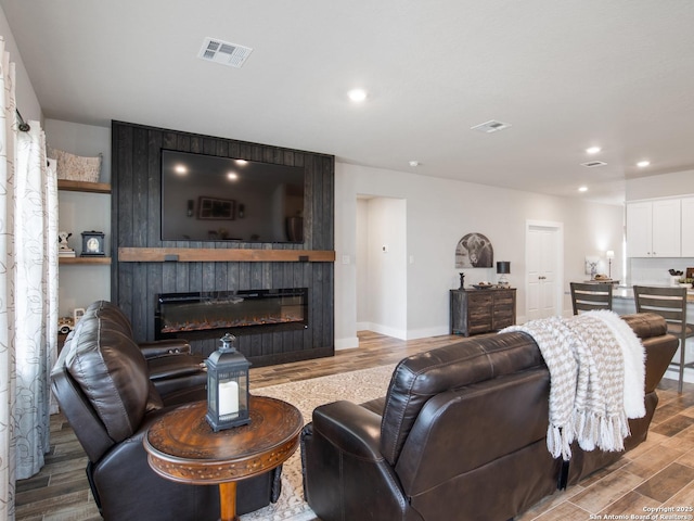 living room featuring light hardwood / wood-style flooring and a fireplace