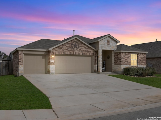 single story home featuring a garage and a lawn