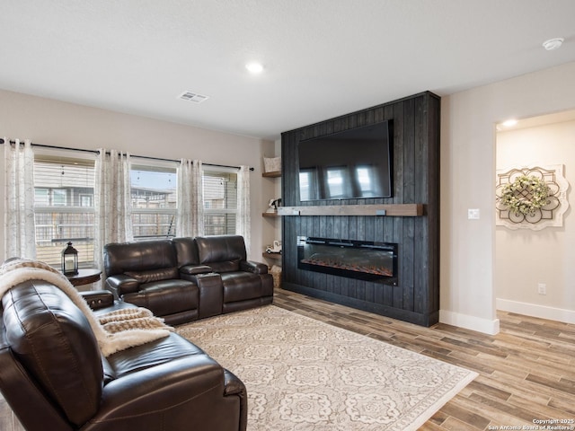 living room with a fireplace and light hardwood / wood-style floors