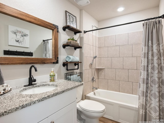 full bathroom featuring toilet, vanity, and shower / bathtub combination with curtain