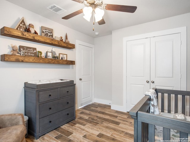 bedroom featuring hardwood / wood-style flooring, a closet, and ceiling fan