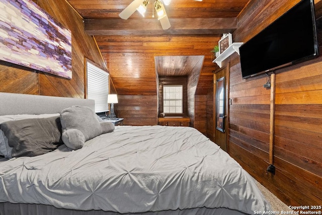 bedroom with ceiling fan, vaulted ceiling, wood ceiling, and wood walls