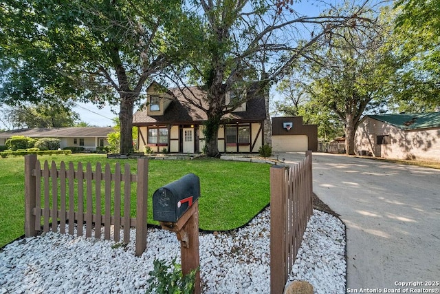 view of front of house with a garage and a front lawn