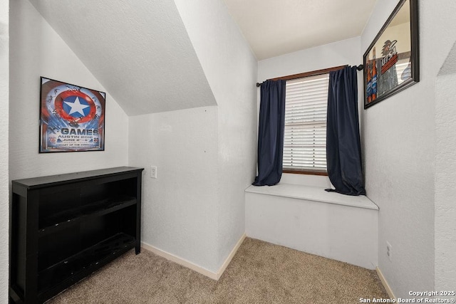 interior space featuring lofted ceiling and light colored carpet