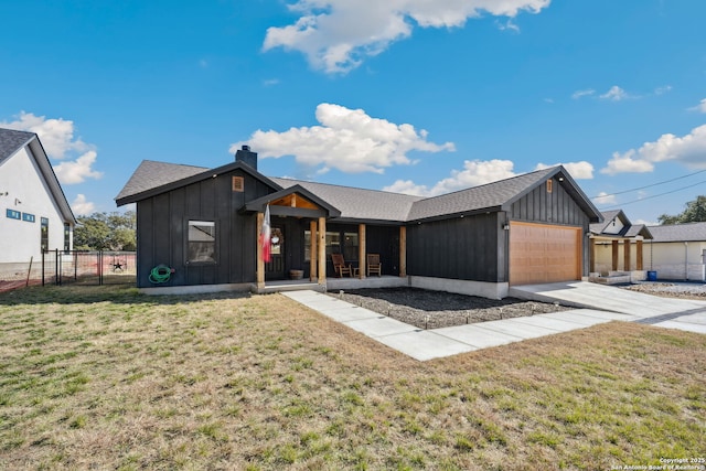 view of front facade with a garage, covered porch, and a front lawn