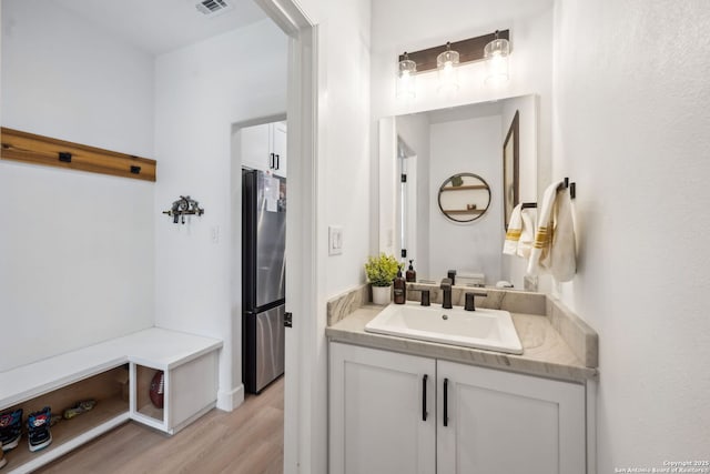 bathroom with hardwood / wood-style flooring and vanity