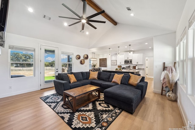 living room with ceiling fan, high vaulted ceiling, beam ceiling, and light hardwood / wood-style floors