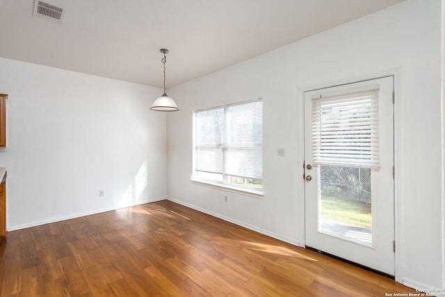 unfurnished dining area with hardwood / wood-style flooring