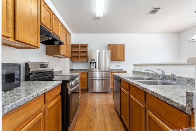 kitchen featuring sink, light hardwood / wood-style flooring, and stainless steel appliances