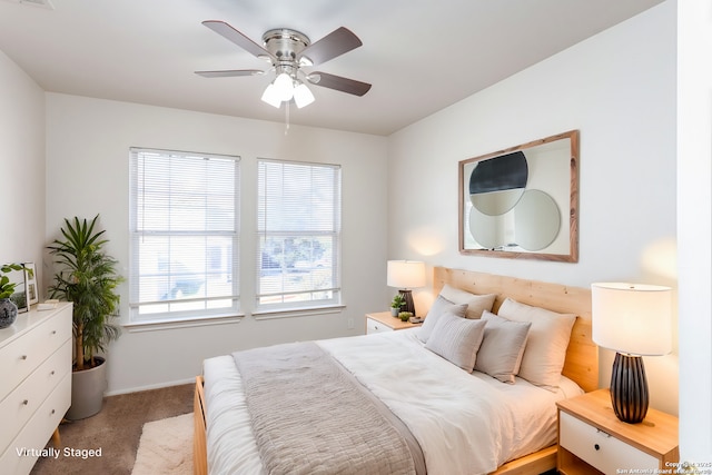 bedroom with ceiling fan and light carpet