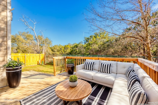 wooden terrace with an outdoor living space