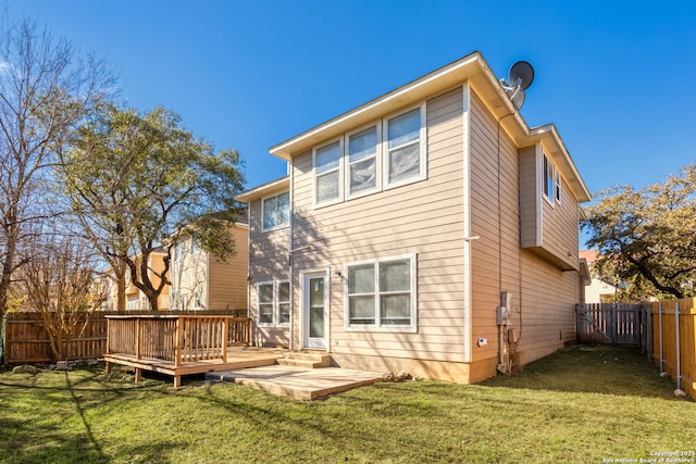 back of property featuring a yard, a deck, and a patio area