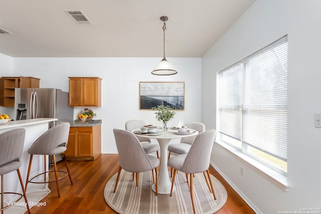 dining room with dark wood-type flooring