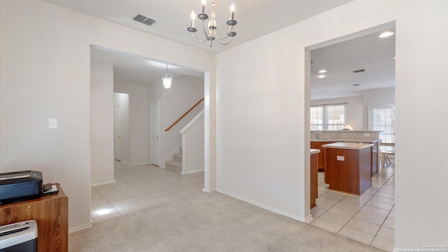 hallway with sink, light colored carpet, a notable chandelier, and heating unit