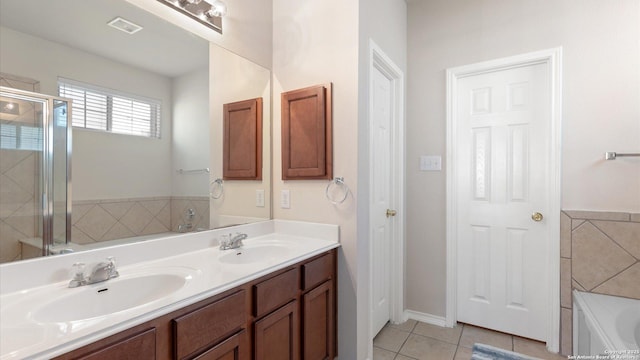 bathroom with tile patterned flooring, vanity, and separate shower and tub