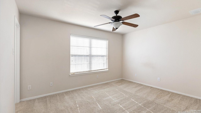 carpeted spare room featuring ceiling fan