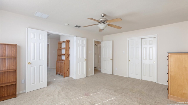 unfurnished bedroom featuring ceiling fan and light carpet