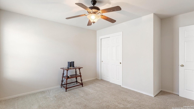 carpeted bedroom with ceiling fan and a closet