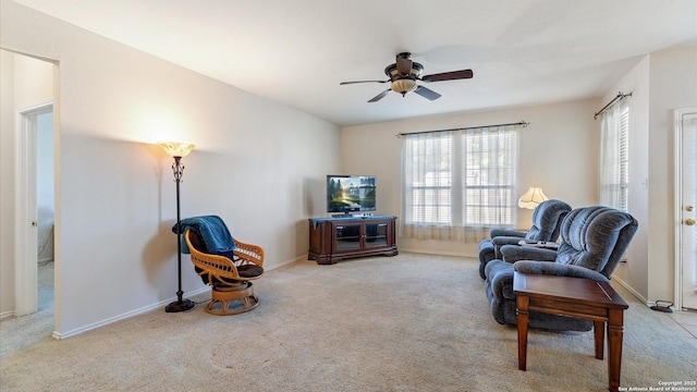 sitting room with ceiling fan and light carpet