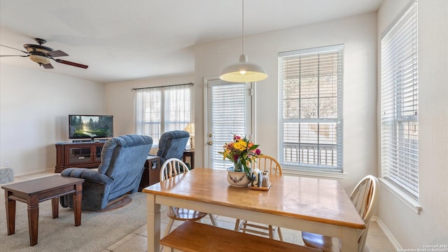 tiled dining room featuring ceiling fan