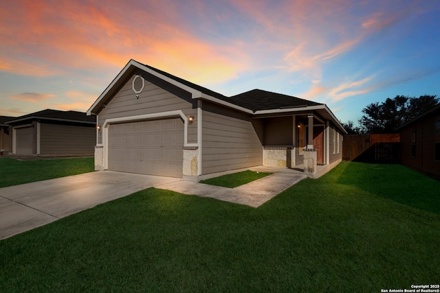 view of front of home featuring a yard and a garage