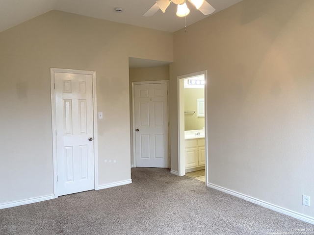 unfurnished bedroom with light carpet, ensuite bath, vaulted ceiling, and ceiling fan