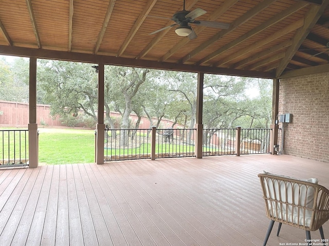 unfurnished sunroom featuring a healthy amount of sunlight and ceiling fan