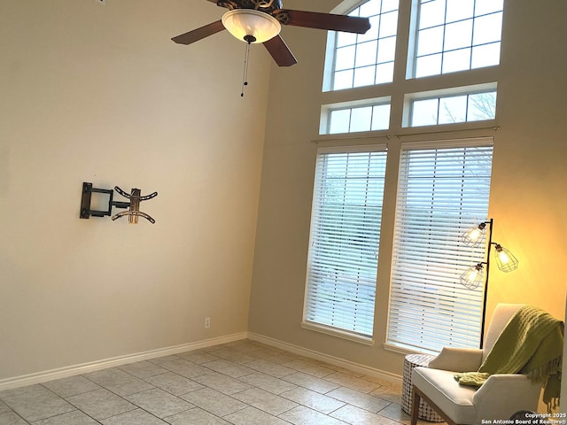 living area featuring ceiling fan, a healthy amount of sunlight, and light tile patterned floors