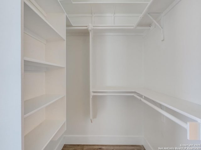 spacious closet featuring hardwood / wood-style floors