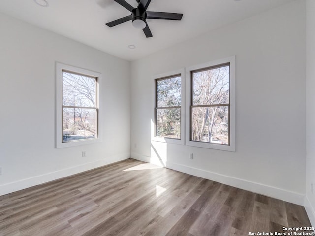 unfurnished room with hardwood / wood-style floors and ceiling fan