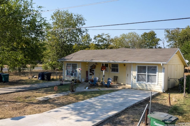 bungalow-style house with cooling unit